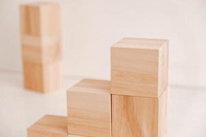 Stack wooden blocks from natural wood on a white background. Copy, empty space for text photo