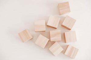 Wooden cubes from natural wood on a white background. Top view. Copy, empty space for text photo