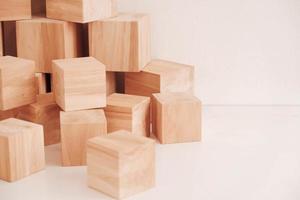 Stack wooden blocks from natural wood on a white background. Copy, empty space for text photo