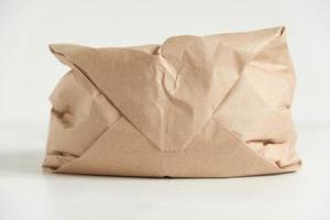 Full disposable bag of brown kraft paper on a white background photo