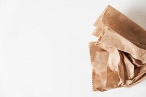 Disposable bag of brown kraft paper on a white background. Copy, empty space for text photo