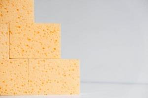 Yellow porous sponges on a white background photo