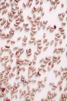 Dry beans are randomly scattered on a white table background. Top view. Copy, empty space for text photo