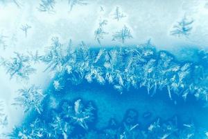 Ice patterns on frozen glass. Abstract ice pattern on winter glass as a background image photo