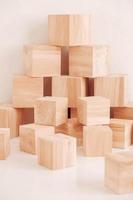 Stack wooden blocks from natural wood on a white background. Copy, empty space for text photo