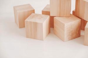 Stack wooden blocks from natural wood on a white background. Copy, empty space for text photo