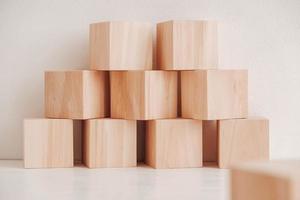 Stack wooden blocks from natural wood on a white background. Copy, empty space for text photo