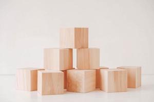 Stack wooden blocks from natural wood on a white background. Copy, empty space for text photo