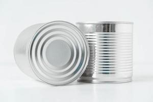 Two aluminum closed metal cans on a white table. Copy, empty space for text photo