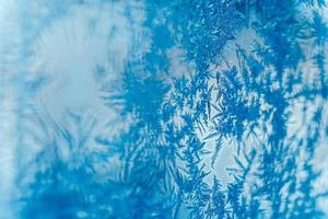 Ice patterns on frozen glass. Abstract ice pattern on winter glass as a background image photo