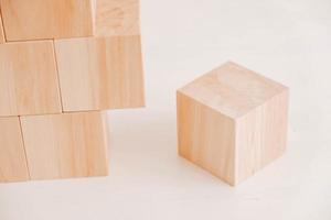 Stack wooden blocks from natural wood on a white background. Copy, empty space for text photo