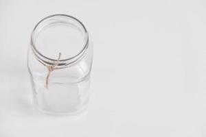 Glass transparent jar on a white table background. Copy, empty space for text photo