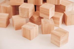 Stack wooden blocks from natural wood on a white background. Copy, empty space for text photo