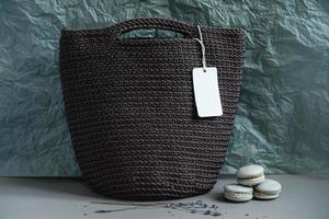 Brown handmade knitted bags on a gray background. Copy, empty space for text photo