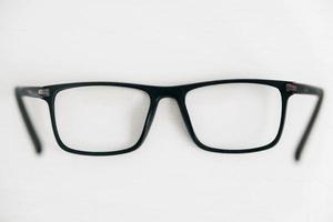 Optical glasses in a dark frame on a white background. Copy, empty space for text photo