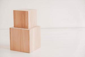 Two wooden blocks from natural wood on a white background. Copy, empty space for text photo