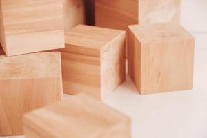 Stack wooden blocks from natural wood on a white background. Copy, empty space for text photo