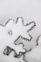 Pine branches covered with snow on a snowy background. Top view. Copy, empty space for text photo