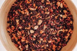 Dry fruit tea in a wooden plate on a white background. Top view. Copy, empty space for text photo