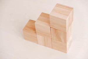 Stack wooden blocks from natural wood on a white background. Copy, empty space for text photo