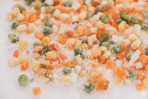 Mix of frozen vegetables on white background photo