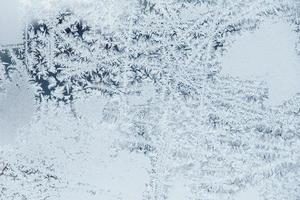 Ice patterns on frozen glass. Abstract ice pattern on winter glass as a background image photo