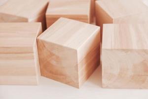 Wooden cubes from natural wood on a white background. Copy, empty space for text photo