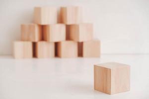 Wooden cubes from natural wood on a white background. Copy, empty space for text photo