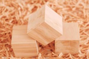 Three wooden block on a background of carpentry shavings. Top view. Copy, empty space for text photo