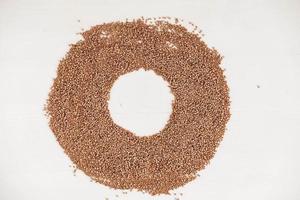 Buckwheat as a background texture in the form of a circle on a white background photo