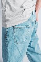 Back pocket of blue jeans. Man s hand in the back pocket of jeans. Copy, empty space for text photo