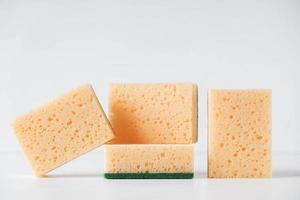 Yellow porous sponges on a white background photo