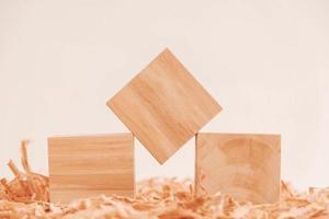 Three wooden block on a background of carpentry shavings. Top view. Copy, empty space for text photo