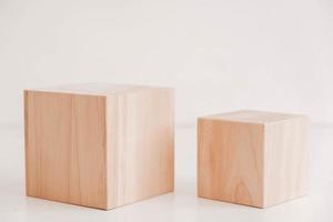 Two wooden blocks from natural wood on a white background. Copy, empty space for text photo