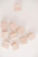 Stack wooden blocks from natural wood on a white background. Top view. Copy, empty space for text photo