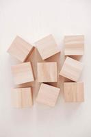 Wooden cubes from natural wood on a white background. Top view. Copy, empty space for text photo