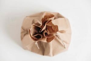 Full disposable bag of brown kraft paper on a white background. Top view. Copy, empty space for text photo