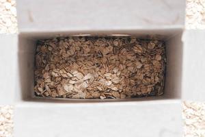 Dry oatmeal in a paper box photo