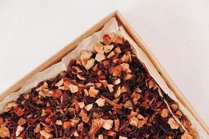 Dry fruit tea in a paper box on a white table background. Top view. Copy, empty space for text photo