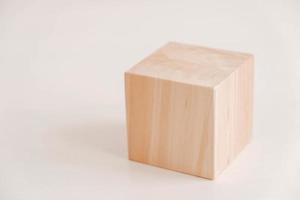 Wooden cube from natural wood on a white background. Copy, empty space for text photo