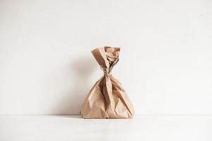 Full disposable bag of brown kraft paper on a white background photo