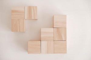 Stack wooden blocks from natural wood on a white background. Top view. Copy, empty space for text photo