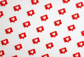 Many 3d social media notifications Love like heart icon in red rounded square pin pattern. 3d render photo