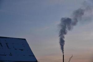 Pipe with smoke in the evening with sunset photo