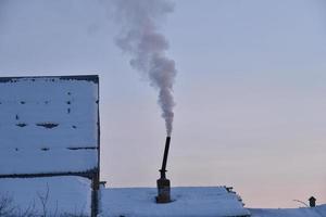 Pipe with smoke in the evening with sunset photo