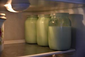 Glass jars with milk in the refrigerator photo