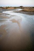 Beautiful view at sunset of Alvor dunes. Small river going to the sea.Algarve, Portugal photo