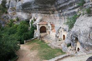 Access to National Monument Ojo Guarena. Caves and church in the rocks. Merindades, Burgos, Spain photo