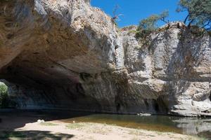 Natural bridge of rock over the river at Puentedey. Bathing area. Merindades, Burgos, Spain photo