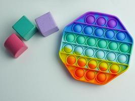 hexagon pop it fidget toy and colorful cube blocks photo